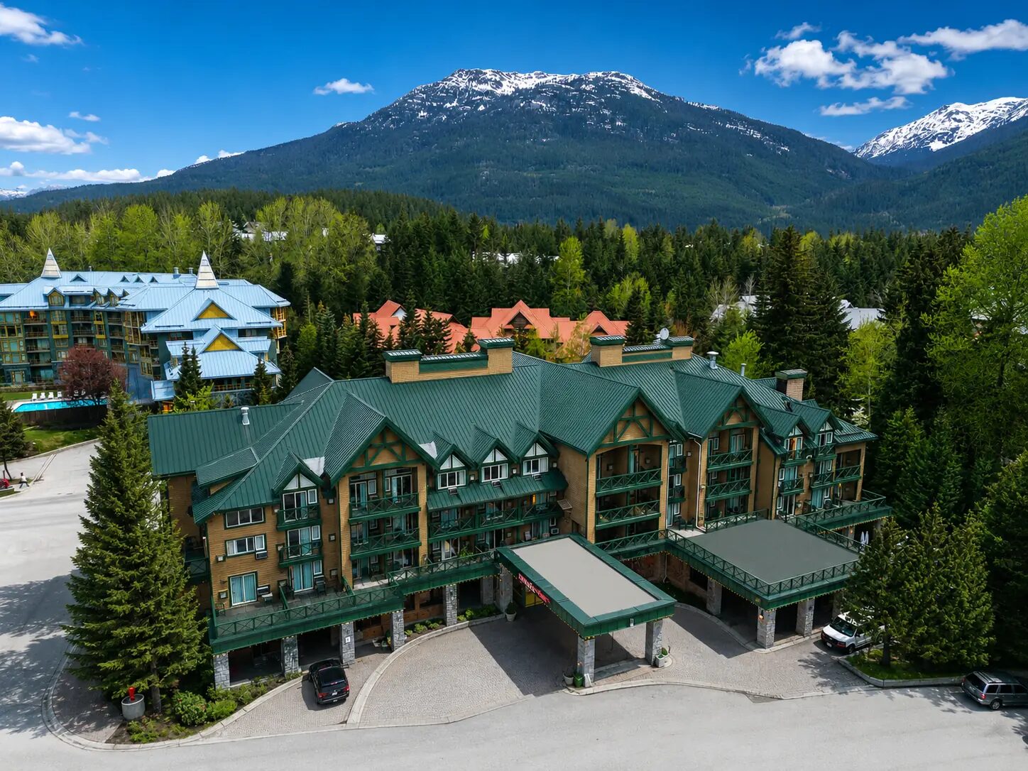 Aerial view of Pinnacle Hotel Whistler Village surrounded by the forested Coast Mountains