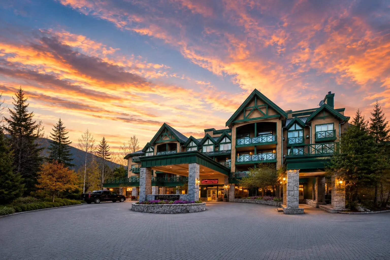 Pinnacle Hotel Whistler Village in summer with Coast Mountain and forest views